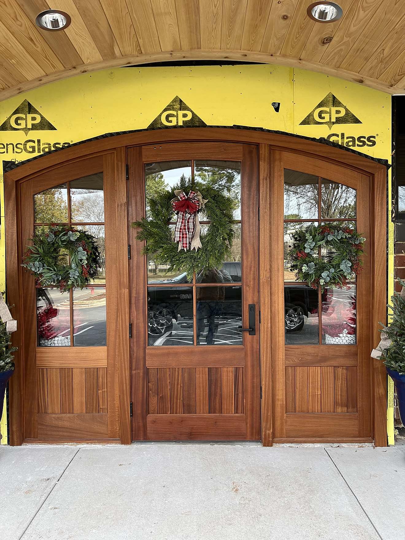 Custom arched double door entrance with glass sidelights, installed