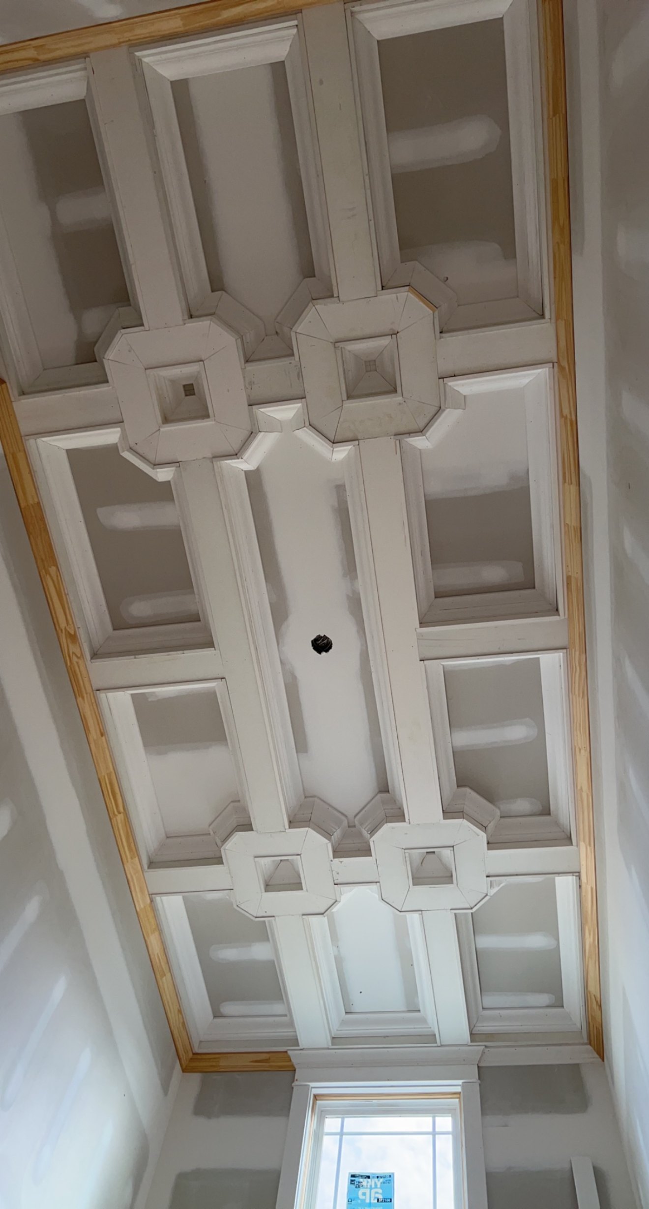 Custom coffered ceiling with octagonal medallion trim detail, architectural millwork