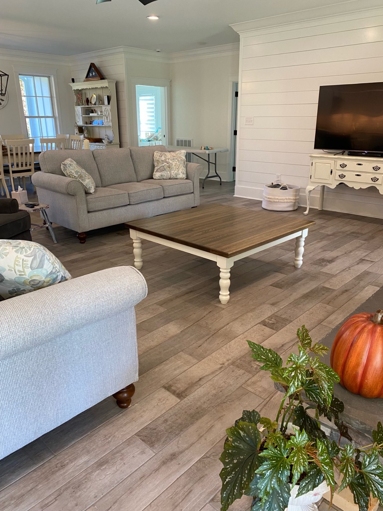 Finished living room with built-in media wall and shiplap paneling